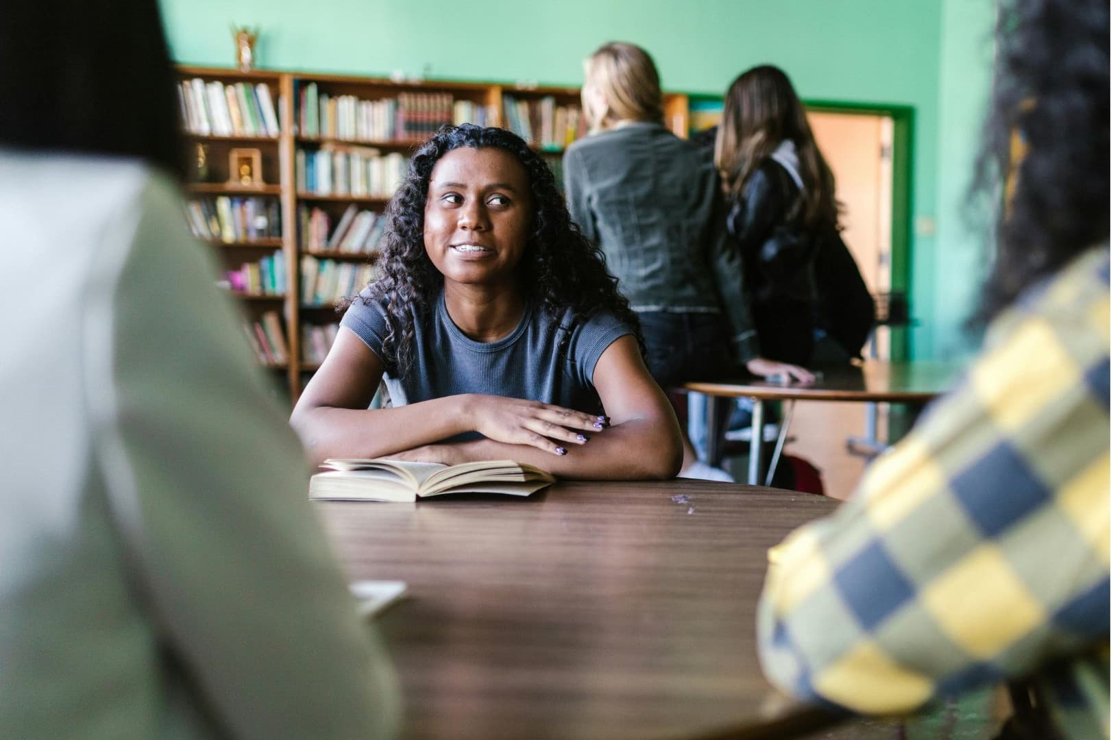 Student with athletic background focused on academics in a library