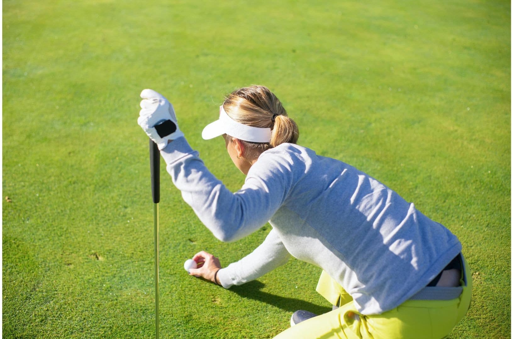 Student-athlete reading the green before a putt