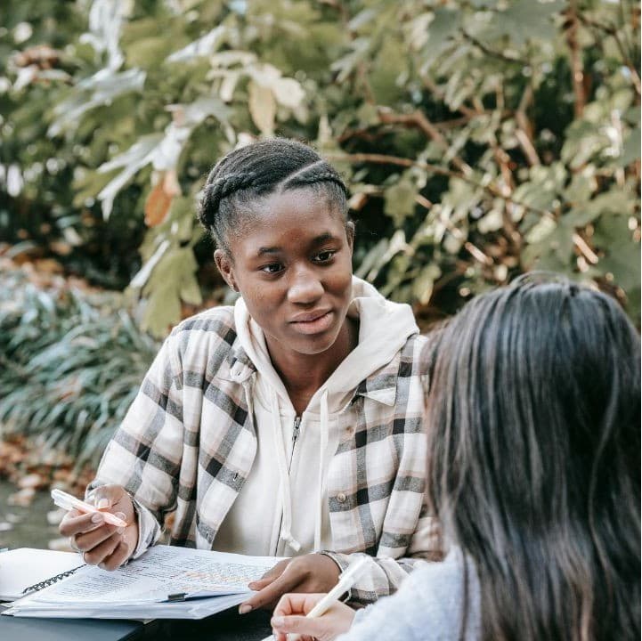 Two students working through college planning together