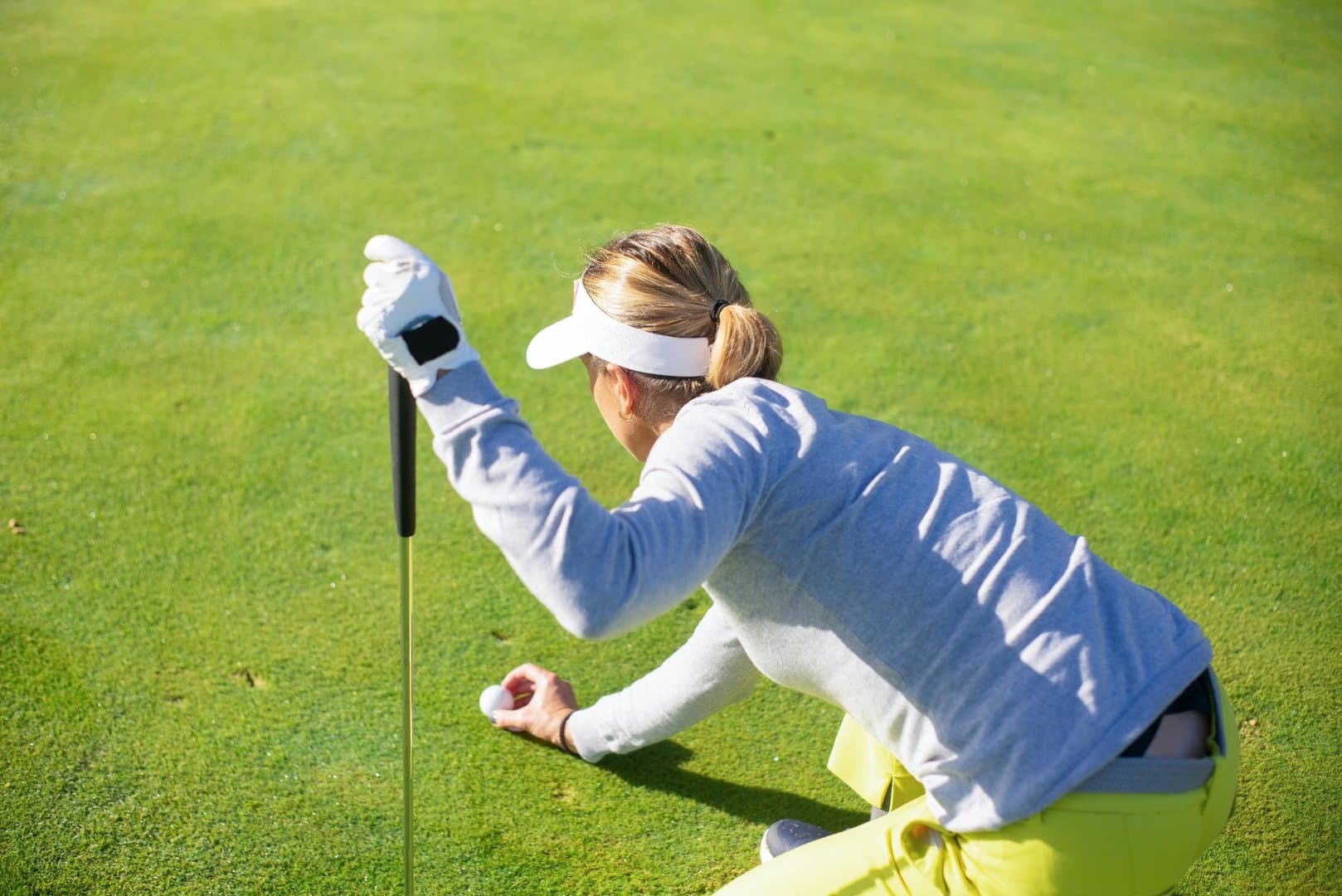 Golfer reading the green before a putt